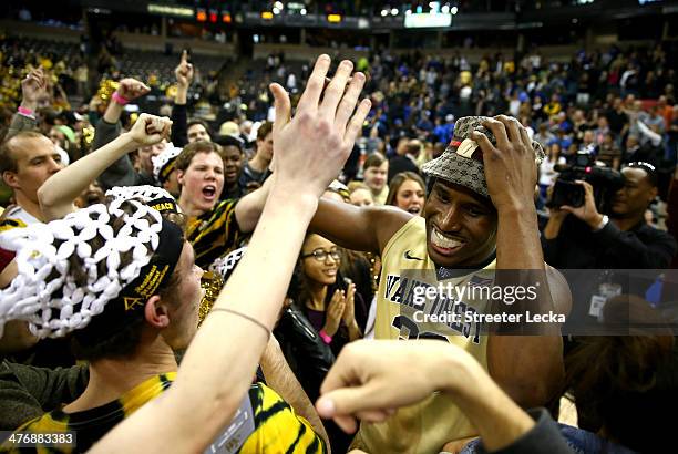 Travis McKie of the Wake Forest Demon Deacons celebrates with students after defeating the Duke Blue Devils 82-72 at Joel Coliseum on March 5, 2014...