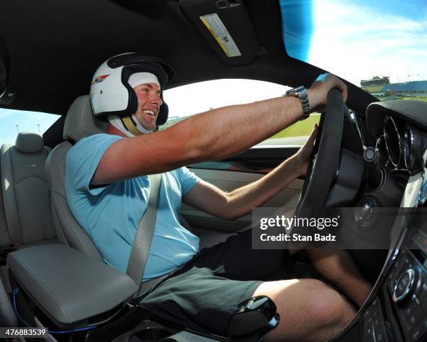 Webb Simpson races his car around the track during the Cadillac V-Series Challenge driving experience at the Homestead-Miami Speedway for the World...