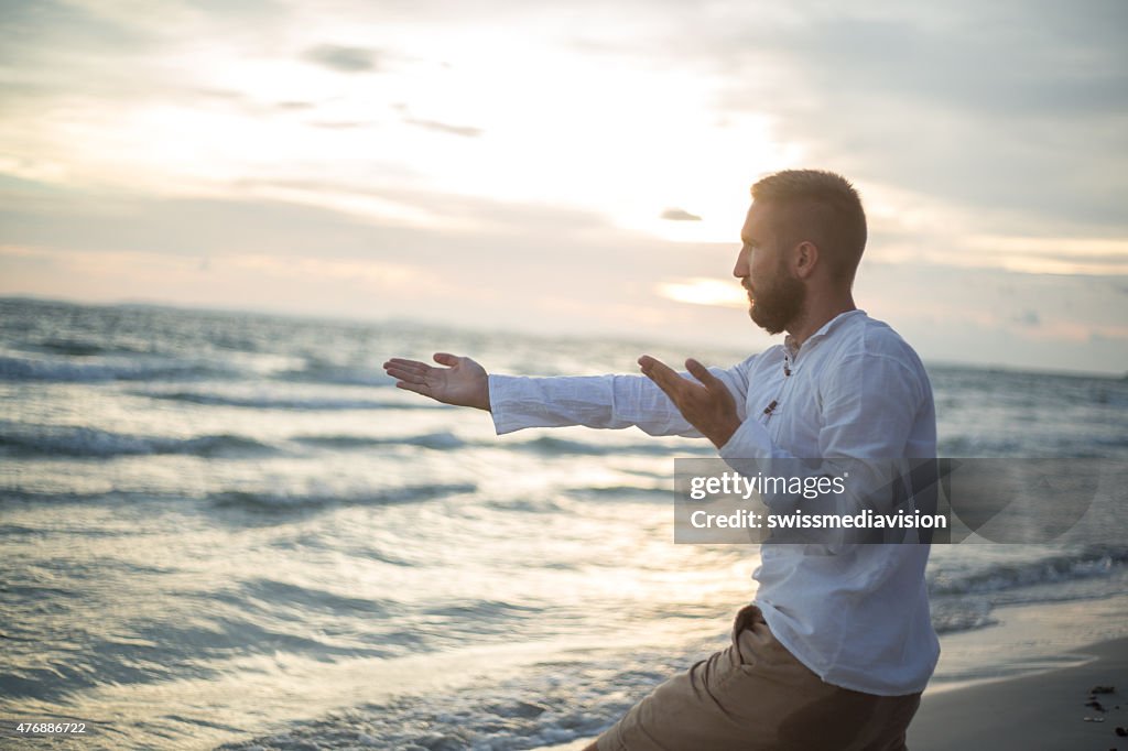 Tai chi e Yoga posizione sulla spiaggia al tramonto