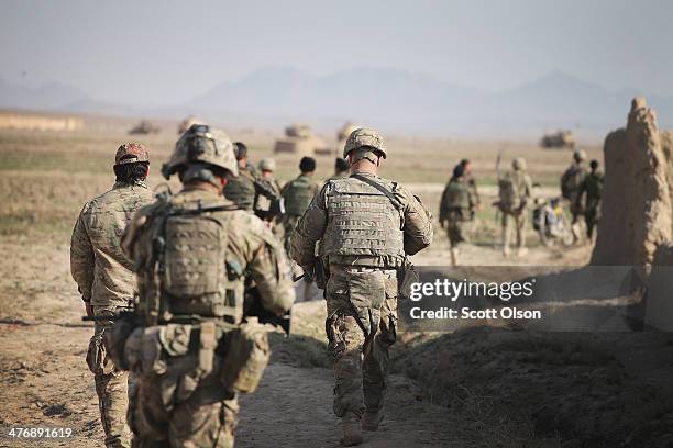 Soldiers with the U.S. Army's 4th squadron 2nd Cavalry Regiment and the Afghan National Army return to their vehicles following a patrol through a...