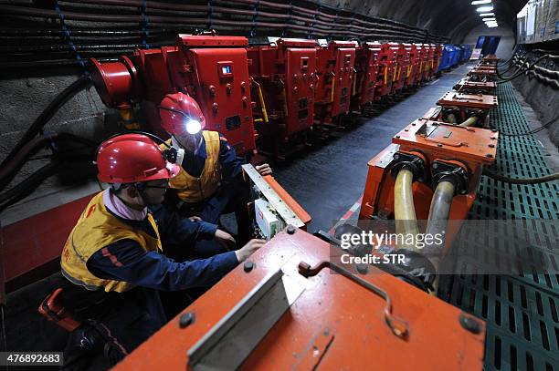 China-environment-energy-politics-Congress,FOCUS by Carol HUANG This picture taken on March 4, 2014 shows laborers working at a coal mining facility...