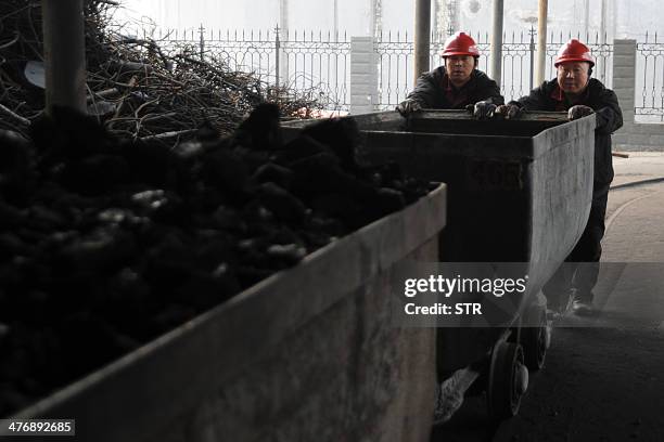 China-environment-energy-politics-Congress,FOCUS by Carol HUANG This picture taken on March 4, 2014 shows laborers working at a coal mining facility...