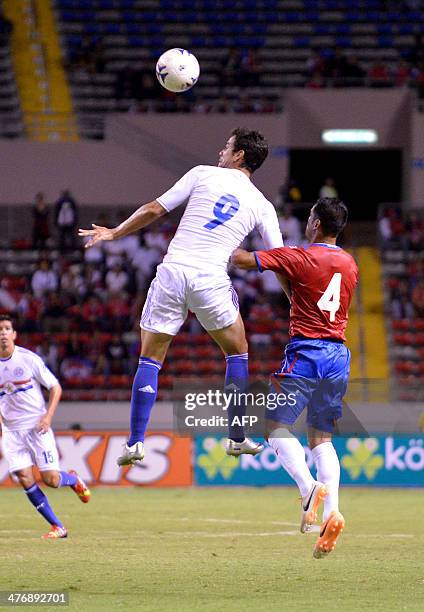 Paraguay's Pablo Velasques vies for the ball against Costa Rican Michael Umaña during a friendly match of the national football team of Paraguay...