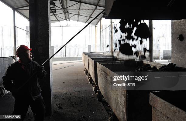 China-environment-energy-politics-Congress,FOCUS by Carol HUANG This picture taken on March 5, 2014 shows a laborer working at a coal mining facility...