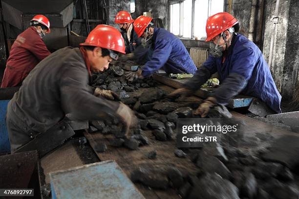 China-environment-energy-politics-Congress,FOCUS by Carol HUANG This picture taken on March 5, 2014 shows laborers working at a coal mining facility...