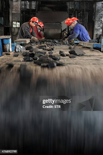 China-environment-energy-politics-Congress,FOCUS by Carol HUANG This picture taken on March 5, 2014 shows laborers working at a coal mining facility...