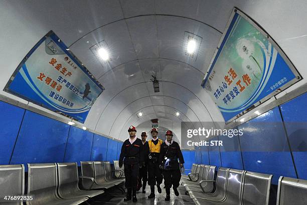 China-environment-energy-politics-Congress,FOCUS by Carol HUANG This picture taken on March 4, 2014 shows laborers walking inside a coal mining...