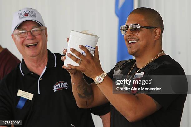 Professional boxer Fernando Vargas holds up a bucket with the cast of his fist during the International Boxing Hall of Fame induction Weekend of...