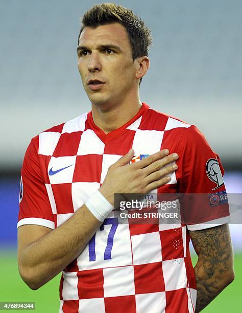 Croatia's forward Mario Mandzukic listens to the national anthem before the Euro 2016 qualifying football match between Croatia and Italy at the...