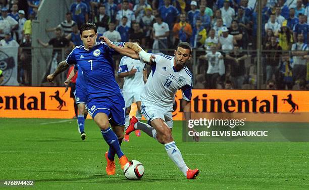 Israel's Ben Sahar with Bosnia's Muhamed Besic during EC 2016 qualifier match played in Zenica, on June 12, 2015. Bosnia won the match 3 : 1. AFP...