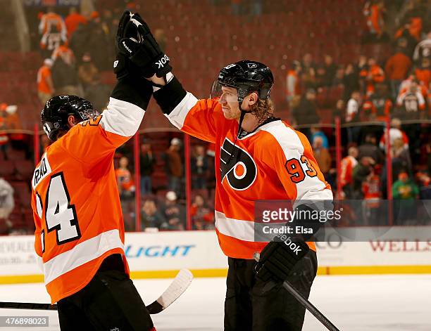 Matt Read and Jakub Voracek of the Philadelphia Flyers celebrate the win after the game at Wells Fargo Center on March 5, 2014 in Philadelphia,...