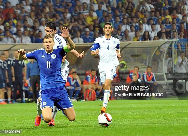 Israel's Omri Ben Harush fouls Bosnia and Herzegovina's Edin Dzeko during EC 2016 qualifying football match played in Zenica, on June 12, 2015....