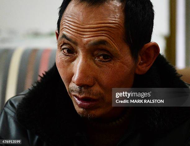 China-environment-energy-politics-Congress,FOCUS by Carol HUANG This photo taken on on February 20, 2014 shows a coal miner surnamed Di at his home...