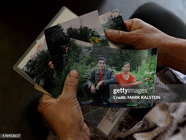 China-environment-energy-politics-Congress,FOCUS by Carol HUANG This photo taken on on February 20, 2014 shows the widow of a deceased coal miner...