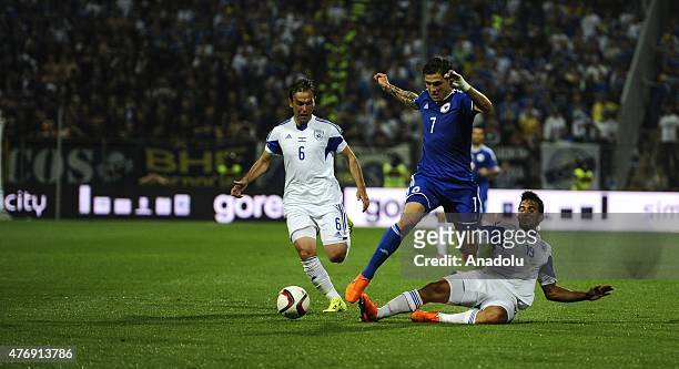 Muhamed Besic of Bosnia in action against Berbas Natcho and Orel Dgani of Israel during the UEFA EURO 2016 qualifying group B soccer match between...