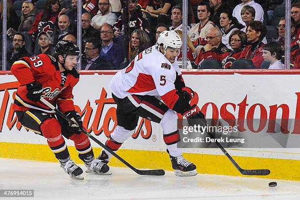 Max Reinhart of the Calgary Flames chases Cody Ceci of the Ottawa Senators during an NHL game at Scotiabank Saddledome on March 5, 2014 in Calgary,...