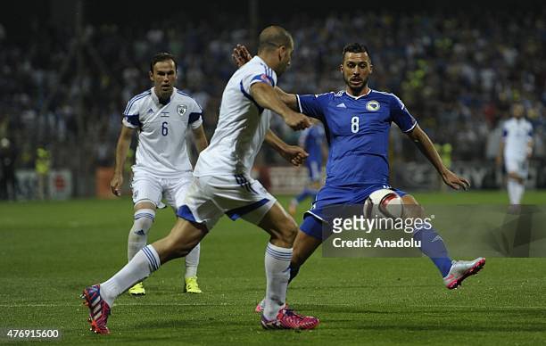 Haris Medunjanin of Bosnia in action against Berbas Natcho of Israel during the UEFA EURO 2016 qualifying group B soccer match between Bosnia and...