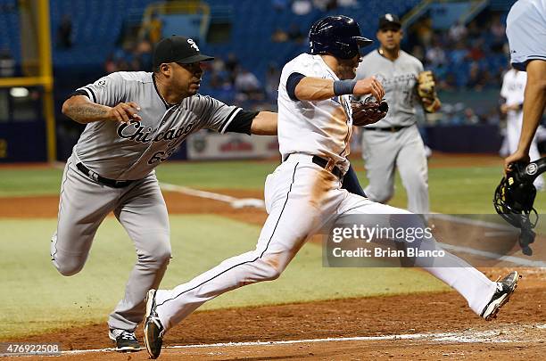 Pitcher Junior Guerra of the Chicago White Sox runs down Kevin Kiermaier of the Tampa Bay Rays for the out to end the eighth inning of a game on June...