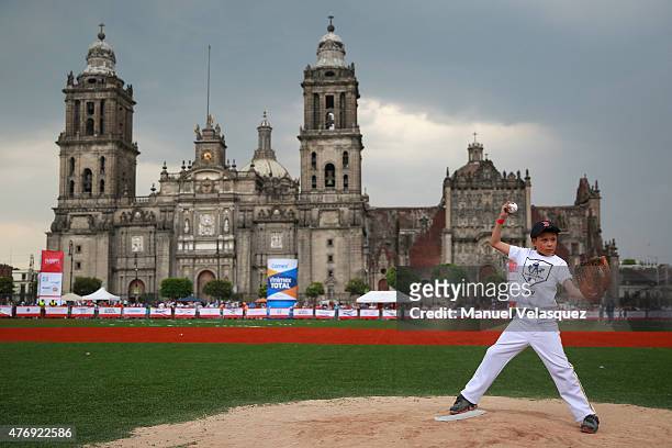 Kid throws a baseball during the day 1 of the Home Run Derby as part of Mexican Baseball League 90th anniversary celebration at Main Square on June...