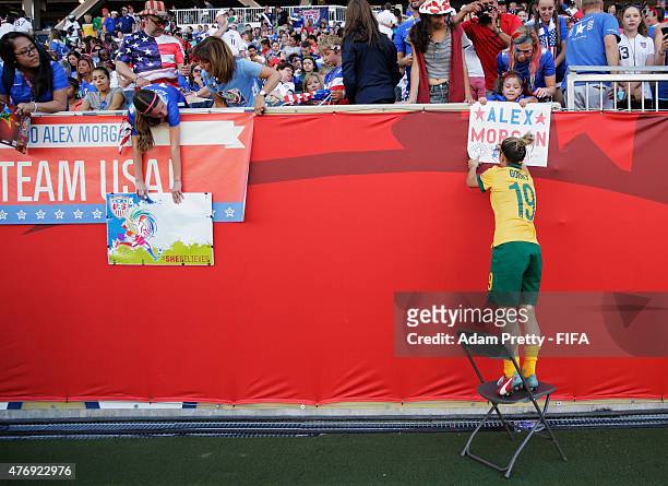 Katrina Gorry of Australia use a chair to help her reach the crowd and sign autographs after the Group D match between Australia and Nigeria of the...