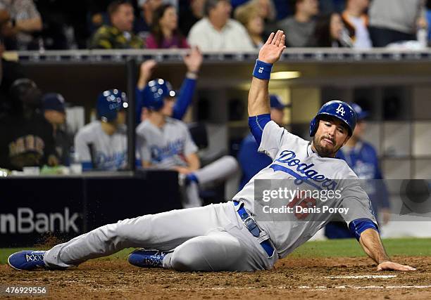 Andre Ethier of the Los Angeles Dodgers slides as he scores during the eighth inning of a baseball game against the San Diego Padres at Petco Park...