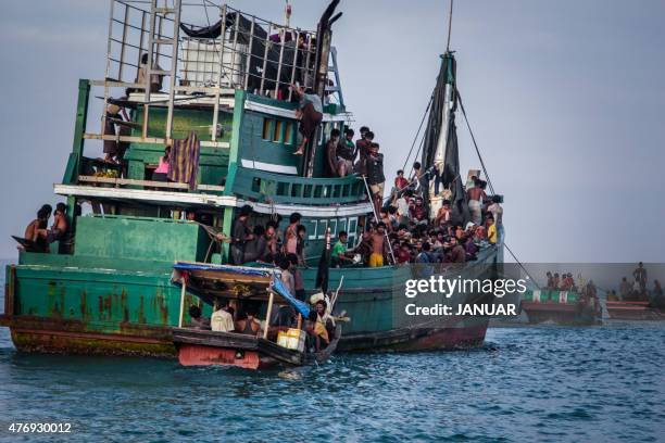 In this photo taken on May 20, 2015 shows Rohingya migrants resting on a boat off the coast near Kuala Simpang Tiga in Indonesia's East Aceh district...