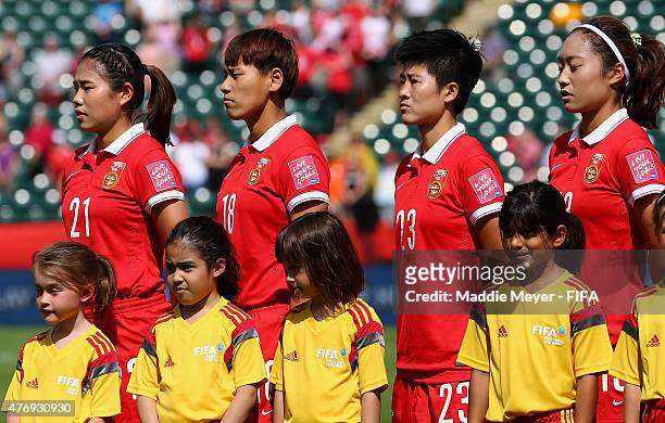Wang Lisi of China PR, Han Peng, Ren Guixin and Tang Jiali stand for their national anthem before the FIFA Women's World Cup Canada 2015 Group A...