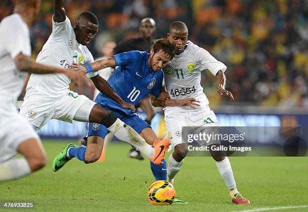 Neymar of Brazil is tackle by Thabo Nthethe and Thato Matlaba of South africad during the International Friendly match between South Africa and...