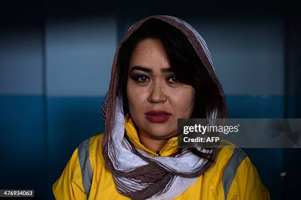 Twenty-one year old Afghanistan national powerlifting team member Sadya Ayubi poses after a training session at a women's gym in a small training...