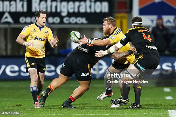 Brad Shields of the Hurricanes offloads to teammate Cory Jane during the round 18 Super Rugby match between the Chiefs and the Hurricanes at Yarrow...