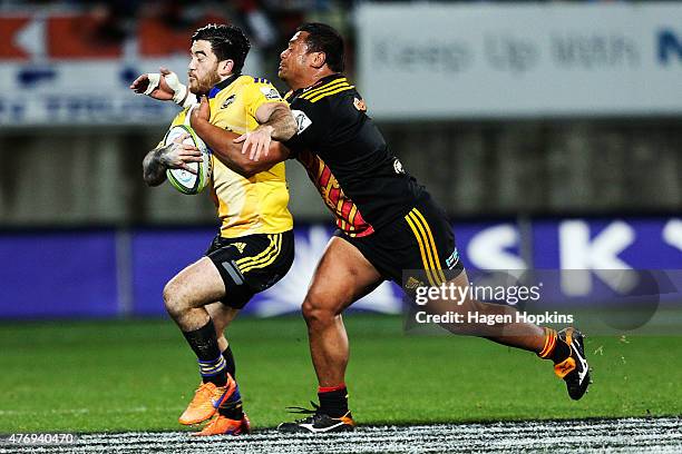 Nehe Milner-Skudder of the Hurricanes is tackled by Pauliasi Manu of the Chiefs during the round 18 Super Rugby match between the Chiefs and the...