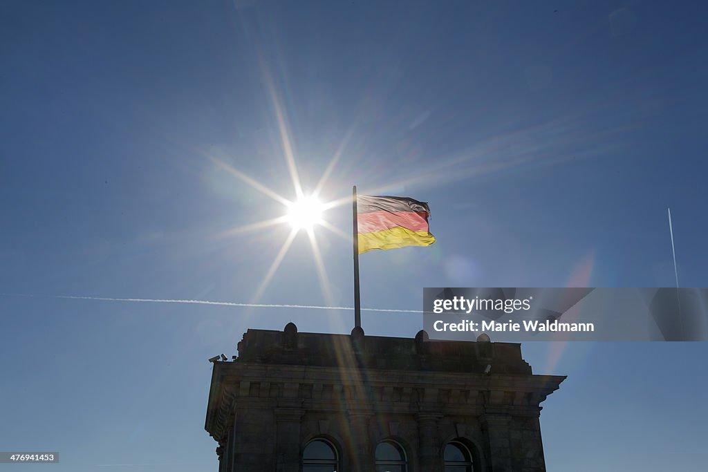 German Flag On Top Off The German Parliament Building With Bright Sunshine.