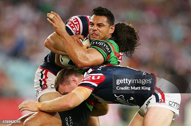 Ben Te'o of the Rabbitohs is tackled during the round one NRL match between the South Sydney Rabbitohs and the Sydney Roosters at ANZ Stadium on...