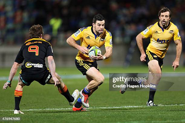 James Marshall of the Hurricanes gets past the defence of Brad Weber of the Chiefs during the round 18 Super Rugby match between the Chiefs and the...