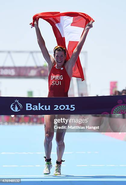 Nicola Spirig of Switzerland celebrates as she crosses the finish line to win the gold medal in the Women's Triathlon Final during day one of the...