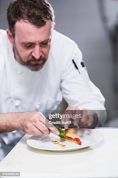 chef in a restaurant plating food - chef plating stock pictures, royalty-free photos & images