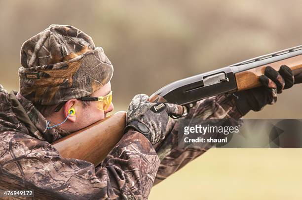 hunter practices shooting - ear plug stock pictures, royalty-free photos & images