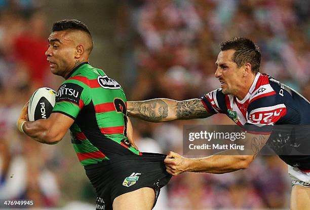 Nathan Merritt of the Rabbitohs is tackled by Mitchell Pearce of the Roosters during the round one NRL match between the South Sydney Rabbitohs and...