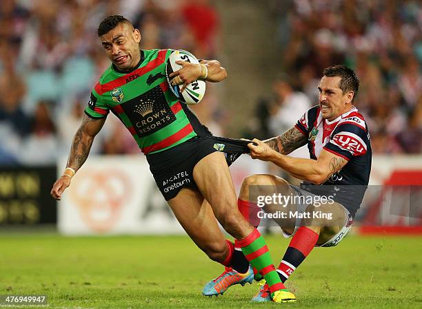 Nathan Merritt of the Rabbitohs is tackled by Mitchell Pearce of the Roosters during the round one NRL match between the South Sydney Rabbitohs and...