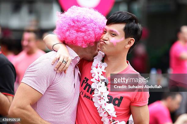Participants dress in various shades of pink mingle during the 'Pink Dot SG' event at Hong Lim Park on June 13, 2015 in Singapore.Pink Dot SG is...