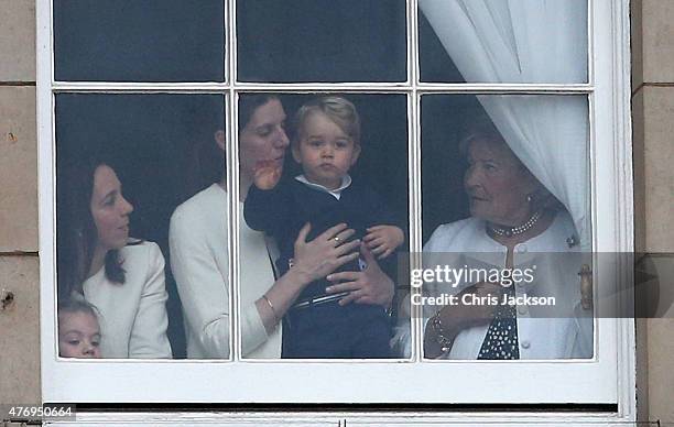 Prince George of Cambridge is held by his nanny Maria Teresa Turrion Borrallo as he waves from the window of Buckingham Palace as he watches the...