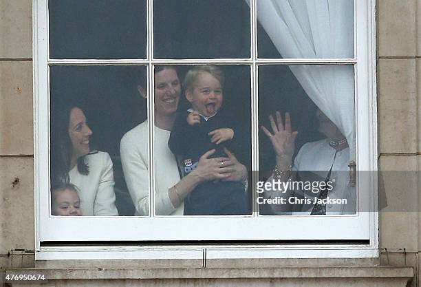 Prince George of Cambridge is held by his nanny Maria Teresa Turrion Borrallo as he waves from the window of Buckingham Palace as he watches the...