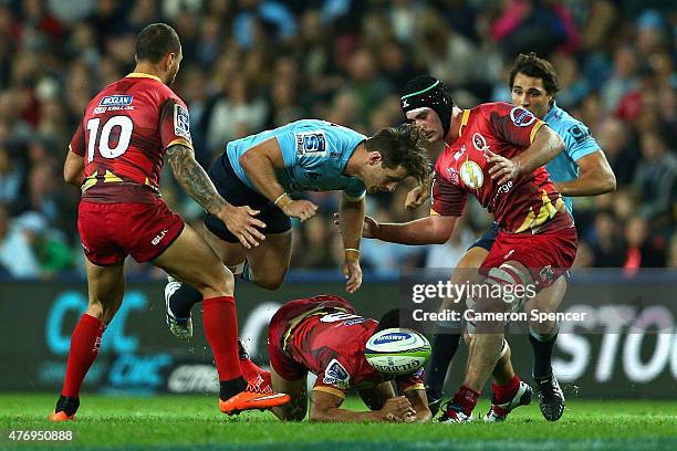 Bernard Foley of the Waratahs and Will Genia of the Reds contest the ball during the round 18 Super Rugby match between the Waratahs and the Reds at...