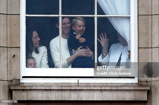 Prince George of Cambridge is held by his nanny Maria Teresa Turrion Borrallo as he waves from the window of Buckingham Palace as he watches the...