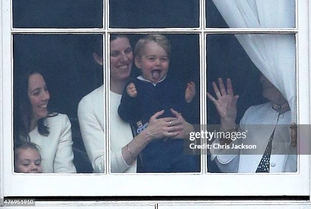 Prince George of Cambridge is held by his nanny Maria Teresa Turrion Borrallo as he waves from the window of Buckingham Palace as he watches the...