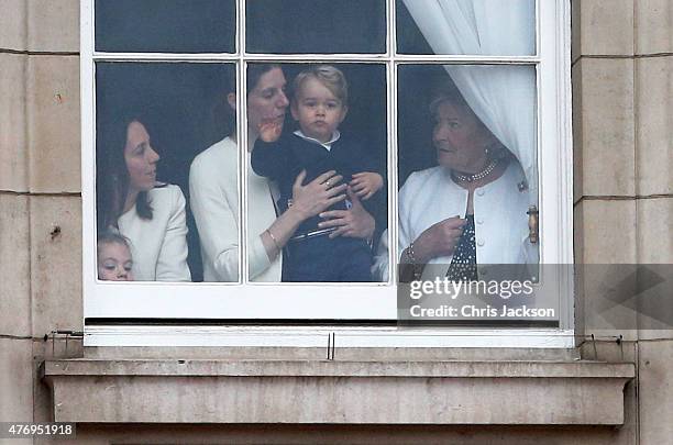 Prince George of Cambridge is held by his nanny Maria Teresa Turrion Borrallo as he waves from the window of Buckingham Palace as he watches the...