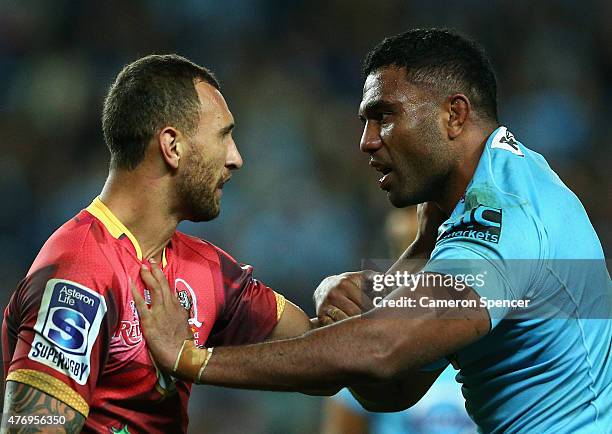 Quade Cooper of the Reds and Wycliff Palu of the Waratahs exchange words during the round 18 Super Rugby match between the Waratahs and the Reds at...