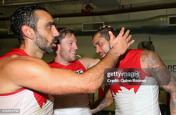 Adam Goodes, Jeremy Laidler and Lance Franklin of the Swans celebrate in the rooms after winning the round 11 AFL match between the North Melbourne...