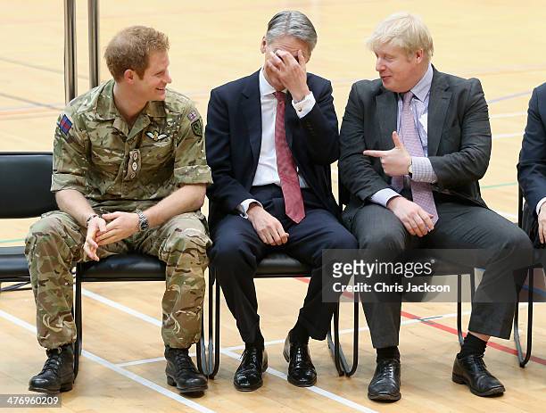Major of London Boris Johnson and Defence Secretary Philip Hammond share a joke and Prince Harry looks on at the media launch for the Invictus Games...