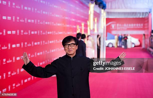 Hong Kong actor Jackie Chan poses on the red carpet during the opening ceremony of the Shanghai International Film Festival in Shanghai on June 13,...